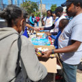 people giving foods to homeless and in need
